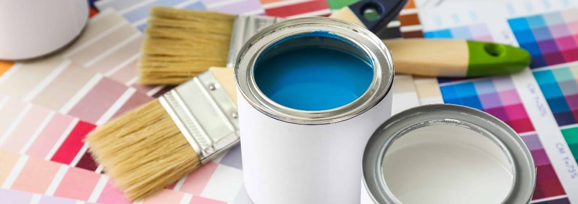 Cans of paint with brushes and palette samples